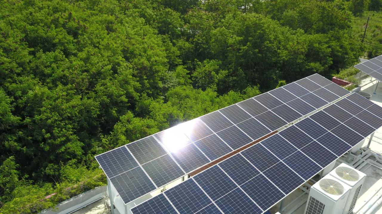 Le Resort And Villas Rawai Eksteriør bilde Solar panels on the roof of the school